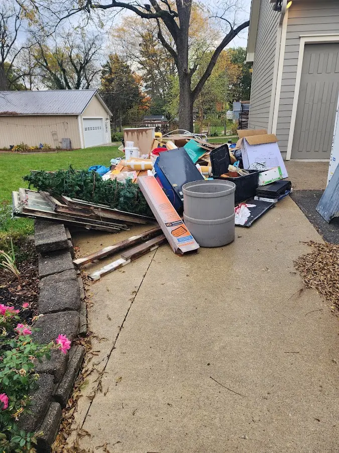 Dumpster being loaded with debris for Estate Cleanout Dumpster Rental in Bayou Vista